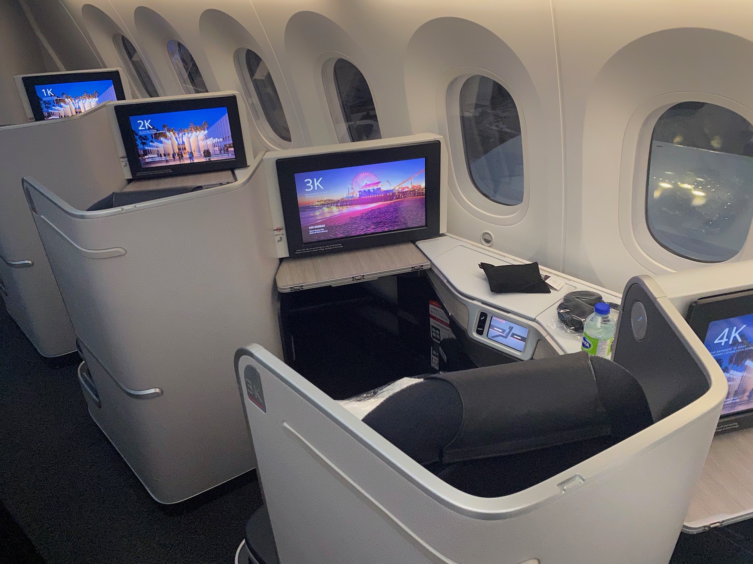 a row of windows with a television on the side of the plane