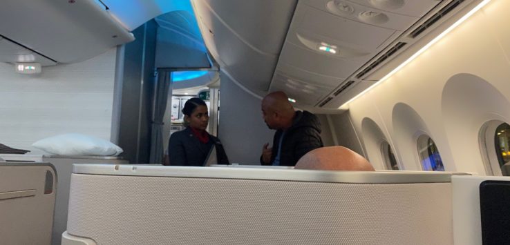 a man and woman sitting in an airplane