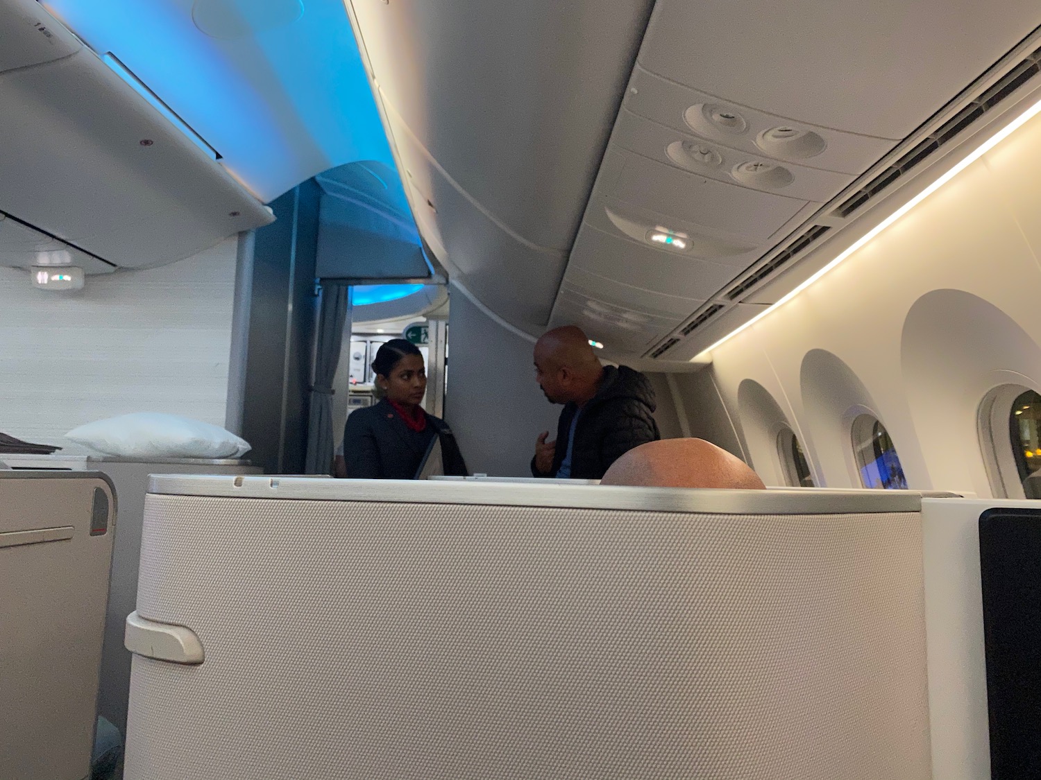 a man and woman sitting in an airplane