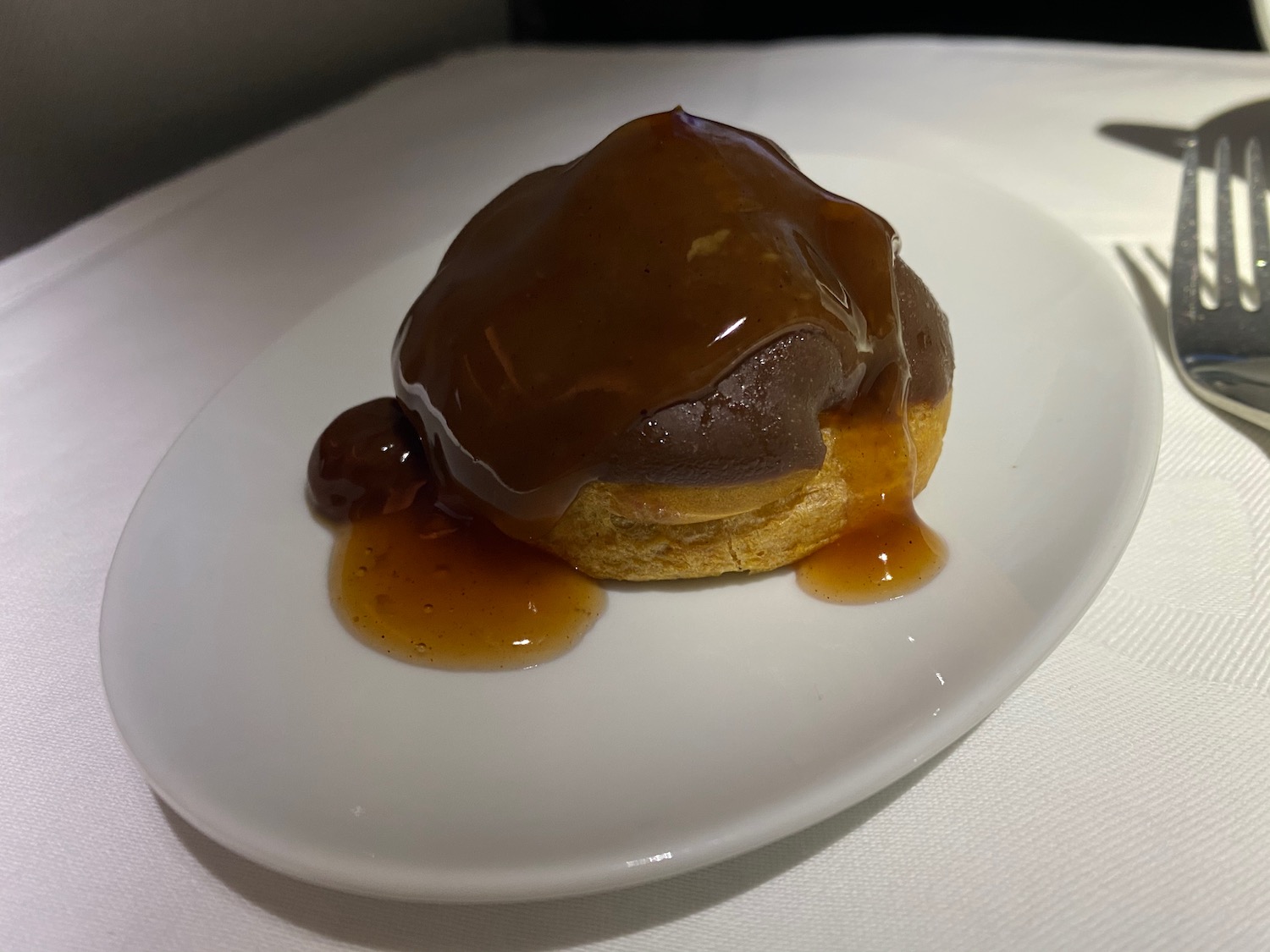 a pastry with brown sauce on a white plate