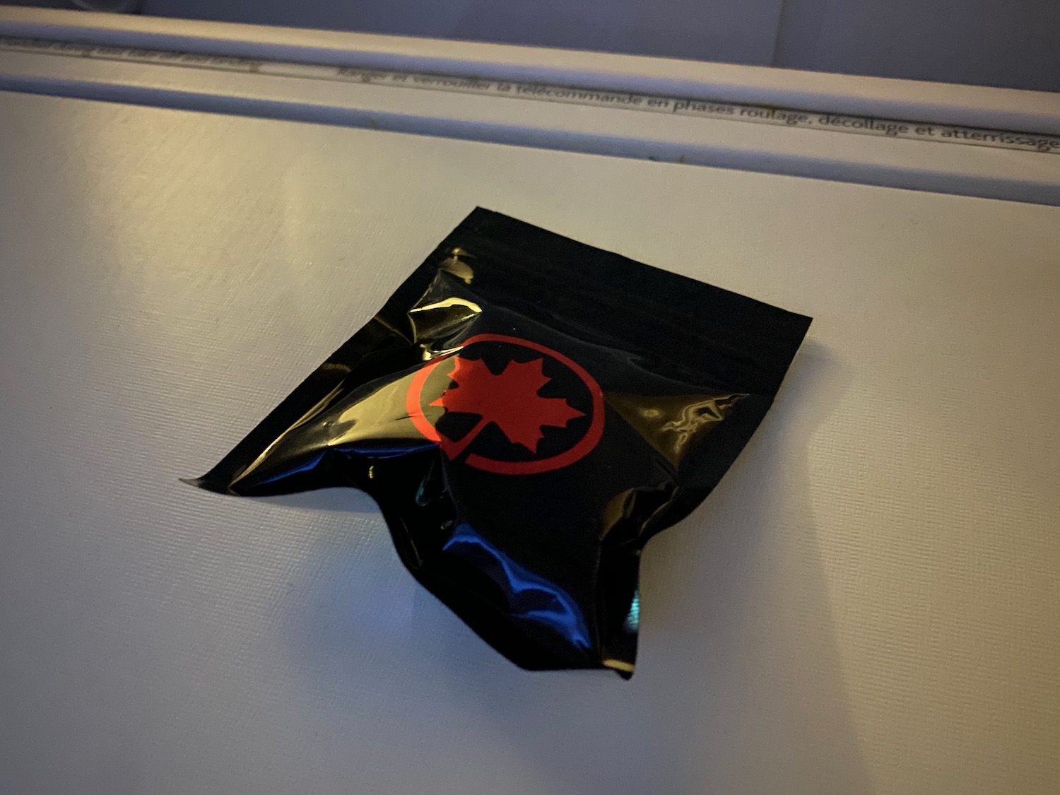 a black plastic bag with a red logo on it