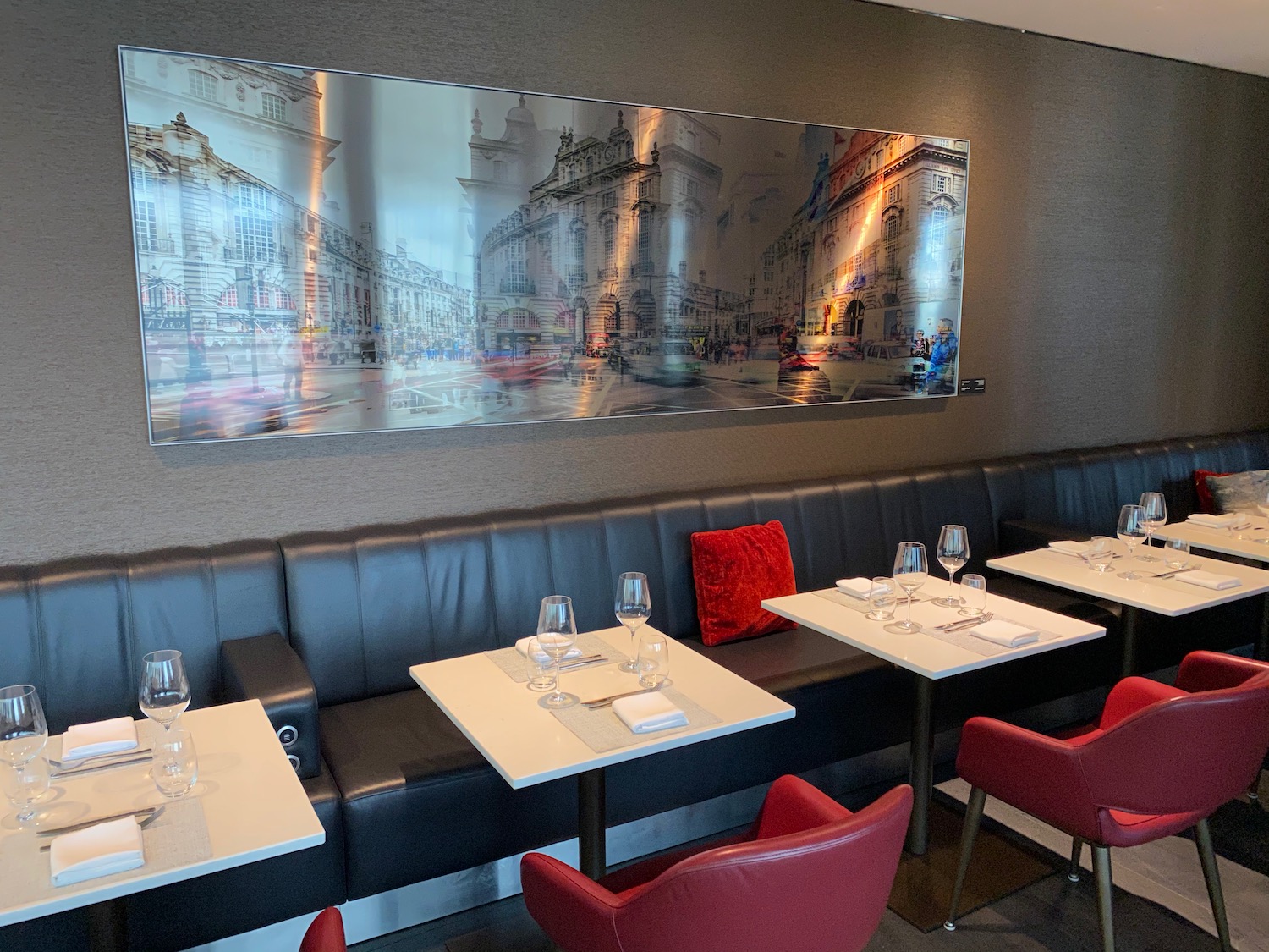 a restaurant booth with tables and chairs