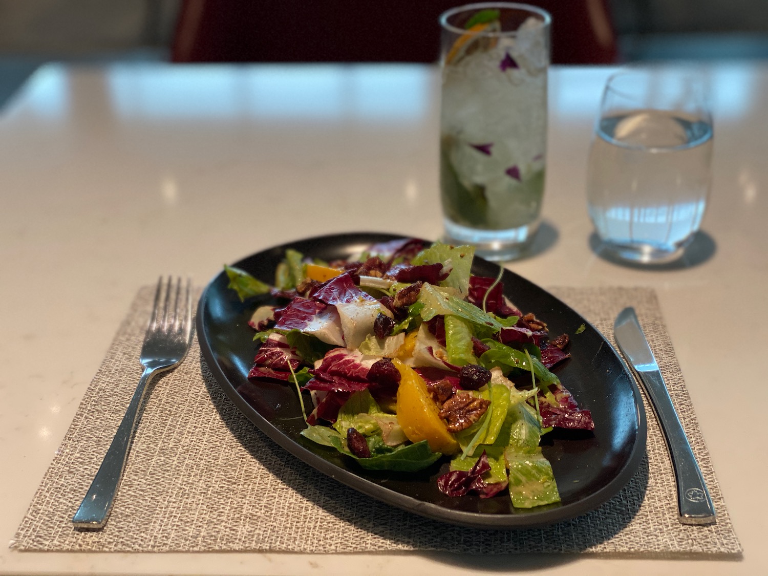 a plate of salad and a fork on a table