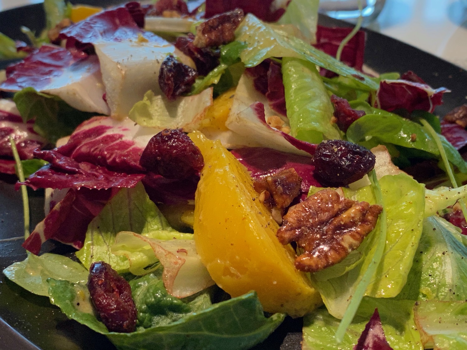 a salad with fruit and nuts