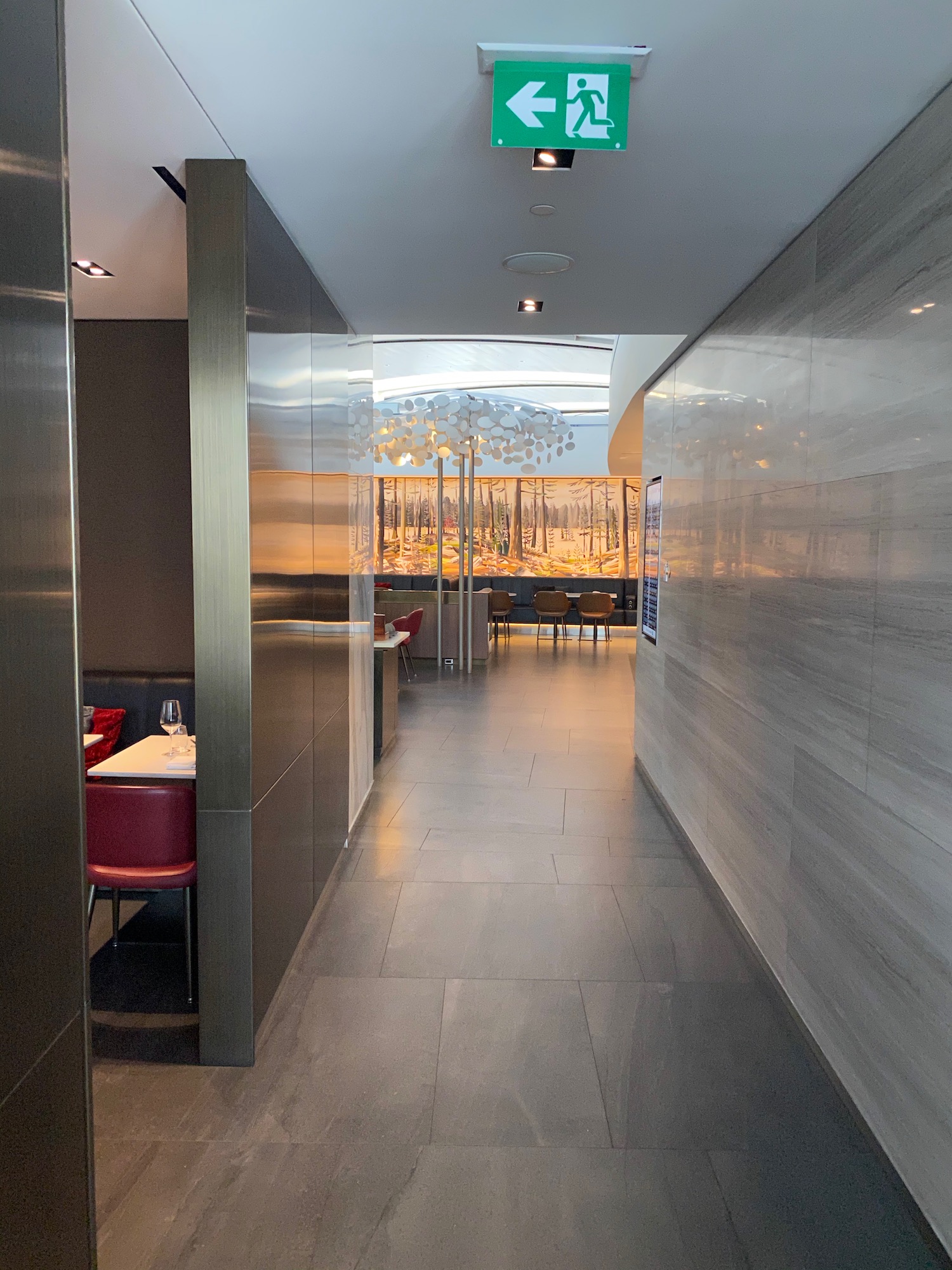 a hallway with a glass wall and a table