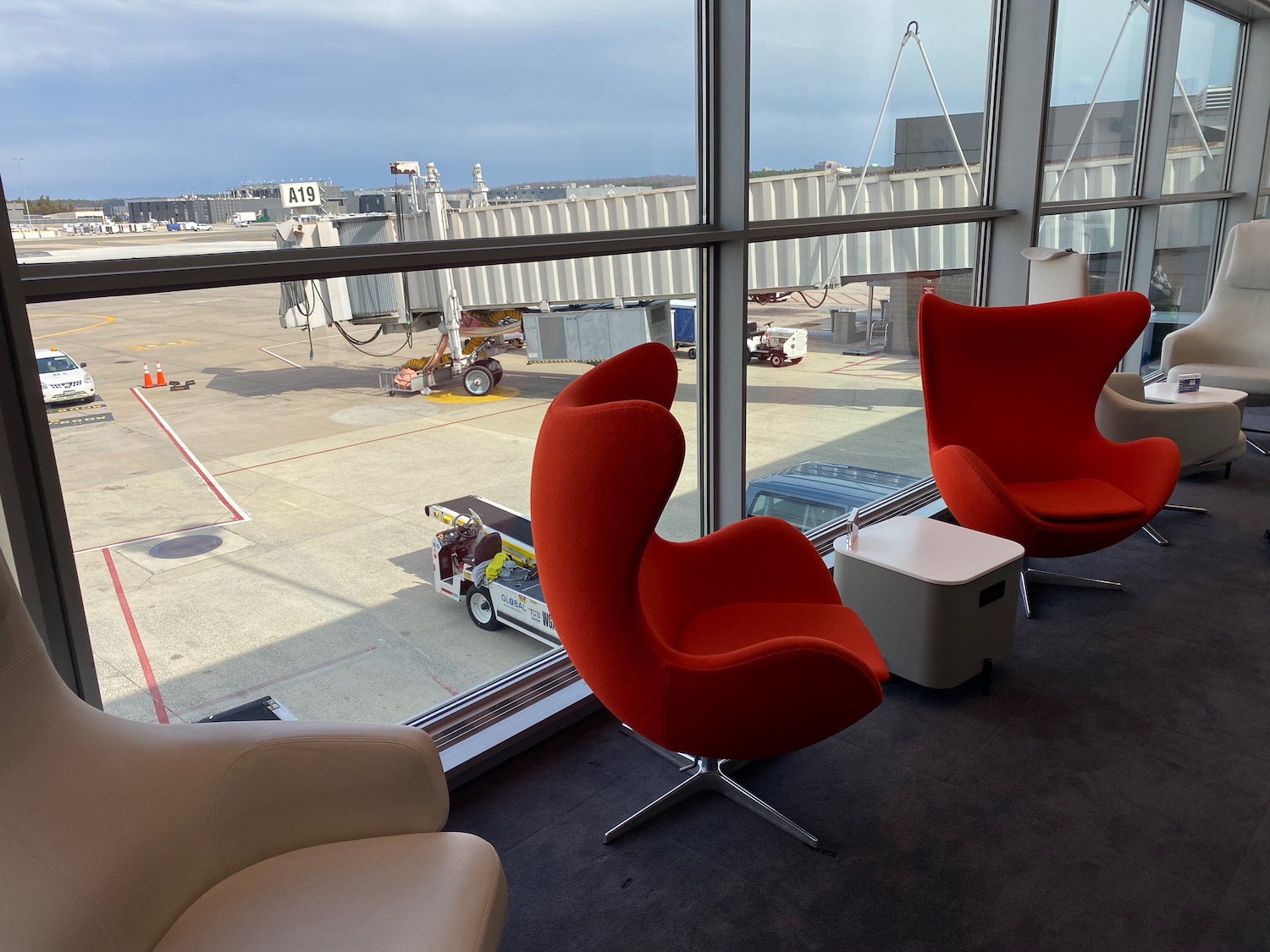 a group of red chairs in a room with a window