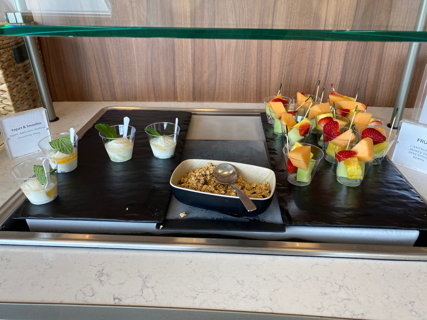 a tray of fruit and yogurt cups