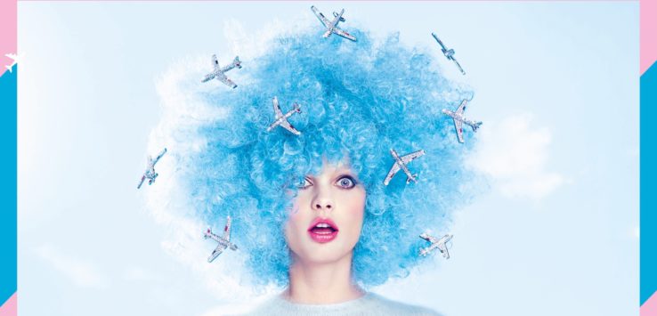 a woman with blue hair and airplanes on her head