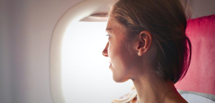 a woman looking out of an airplane window