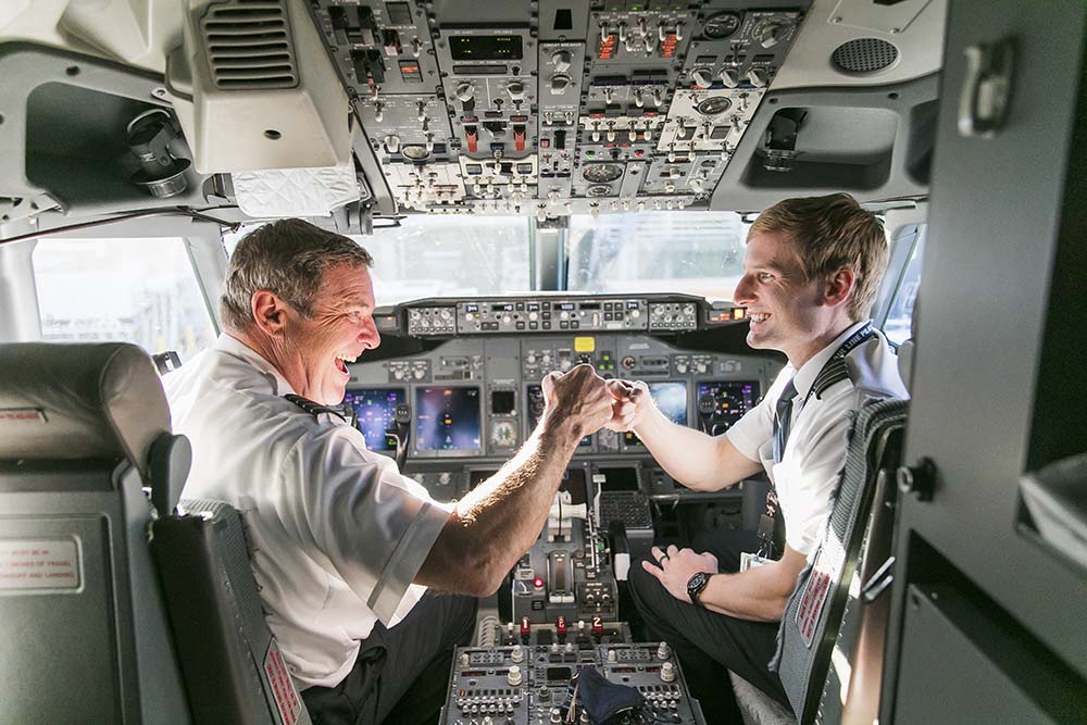 two men in the cockpit of an airplane