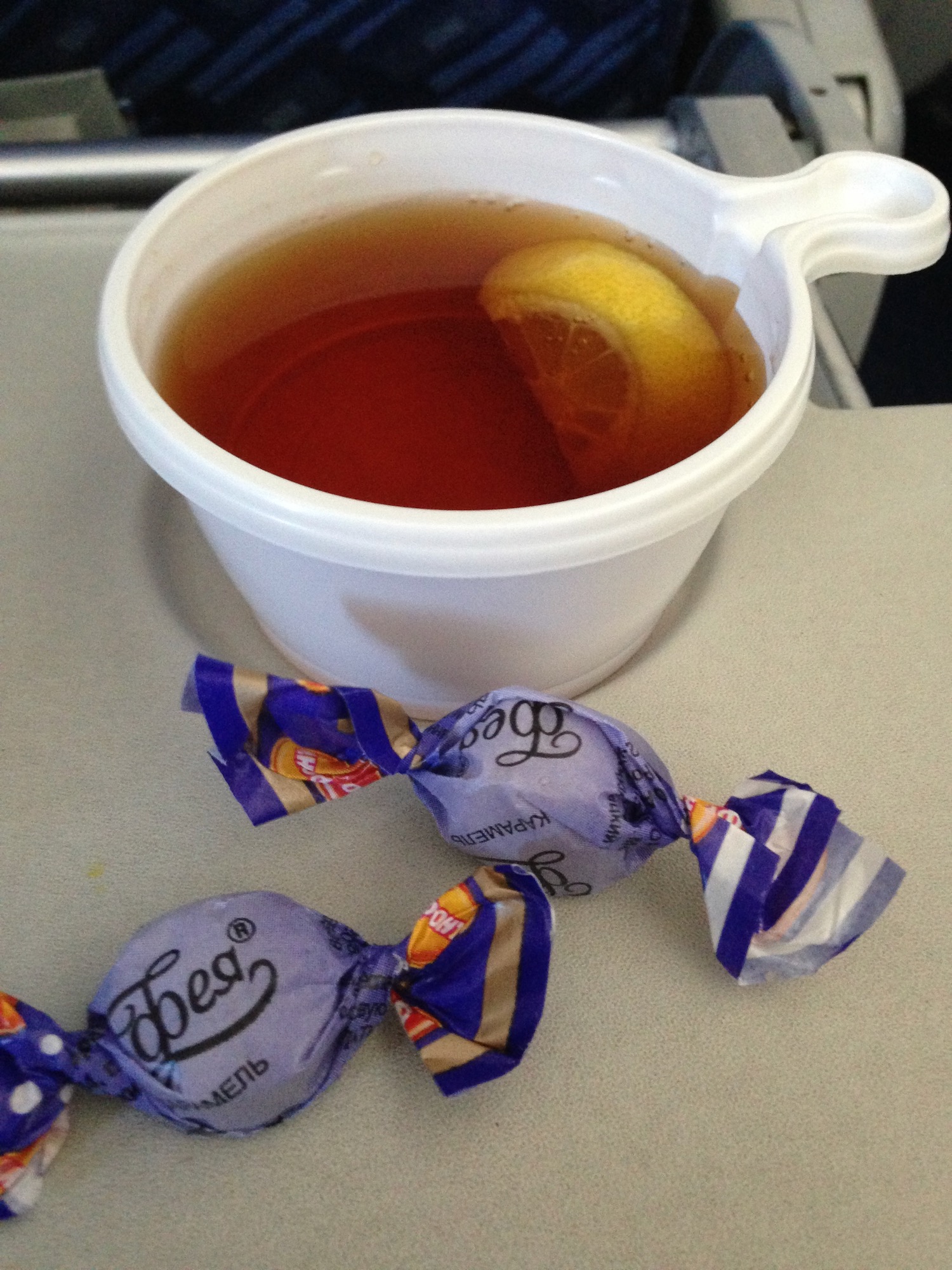 a cup of tea with lemon and candy