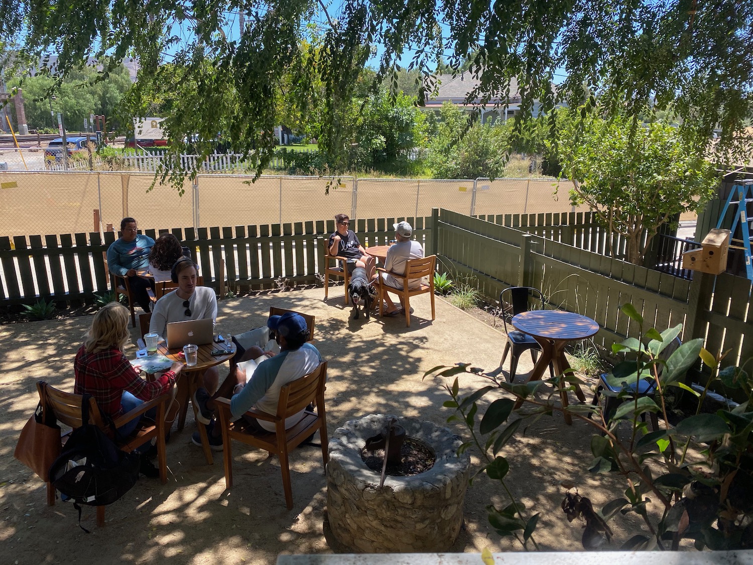 a group of people sitting around a table outside