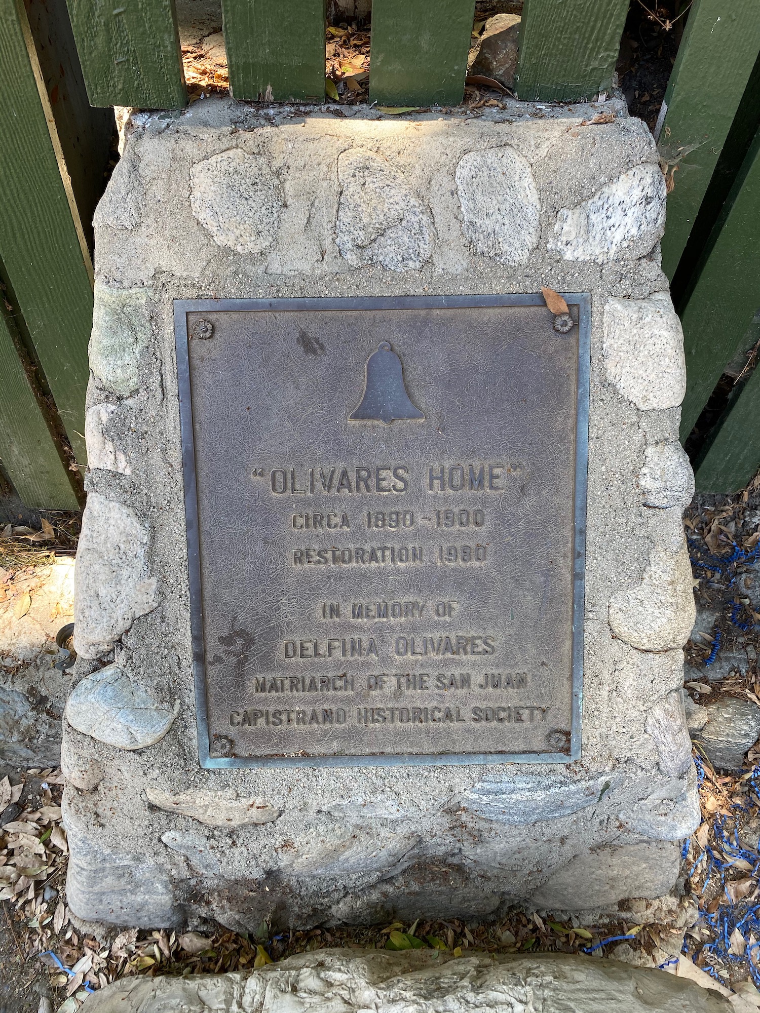 a stone plaque with a bell on it