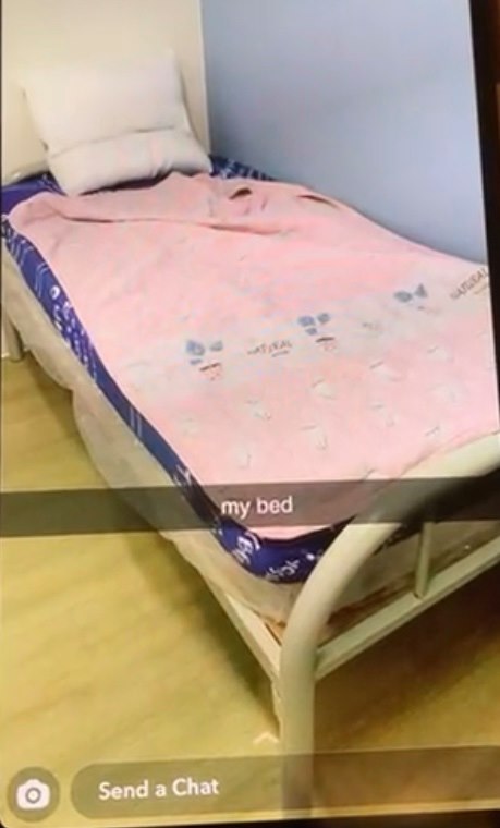 a bed with a pink blanket