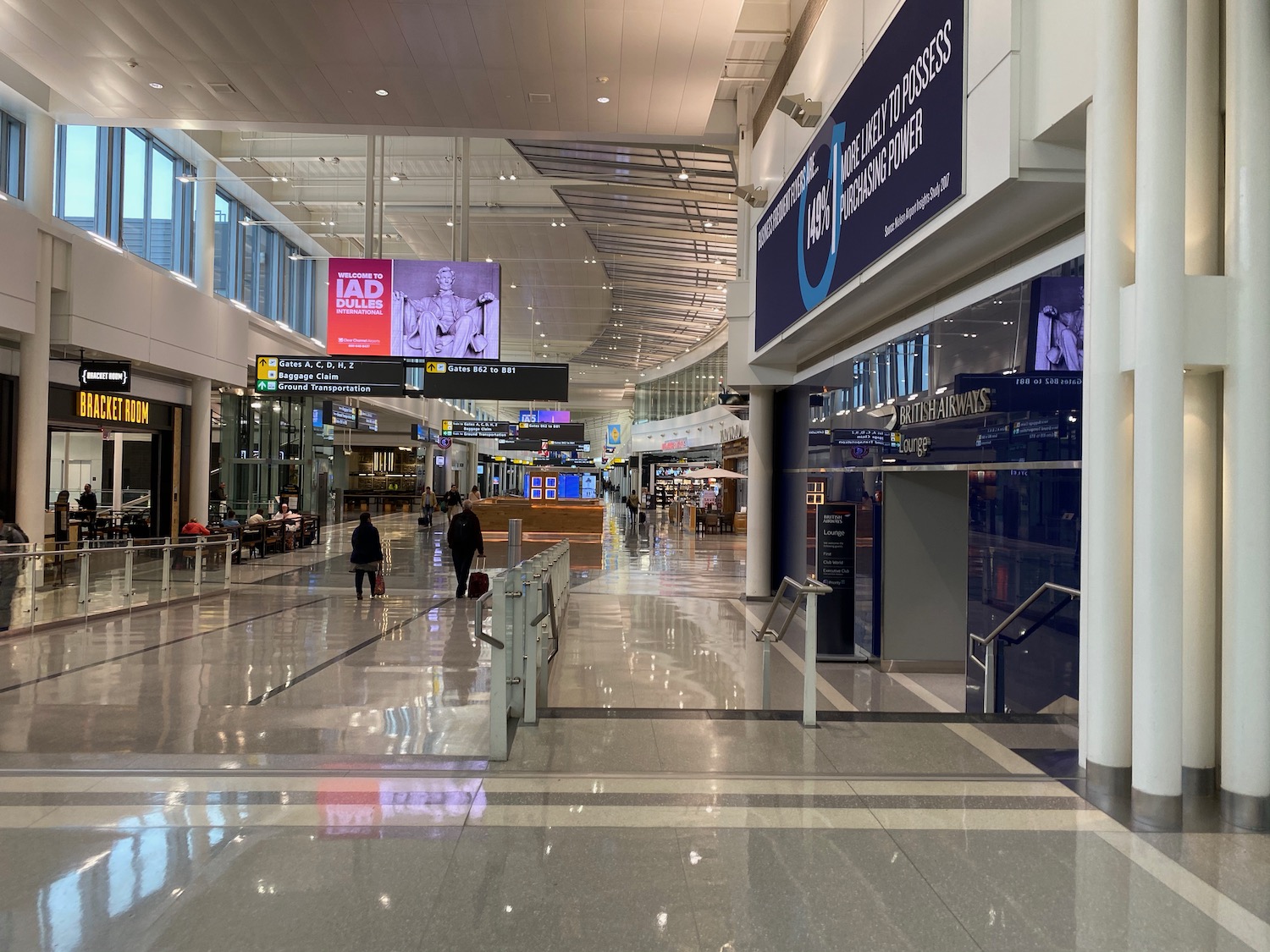 a large airport terminal with people walking