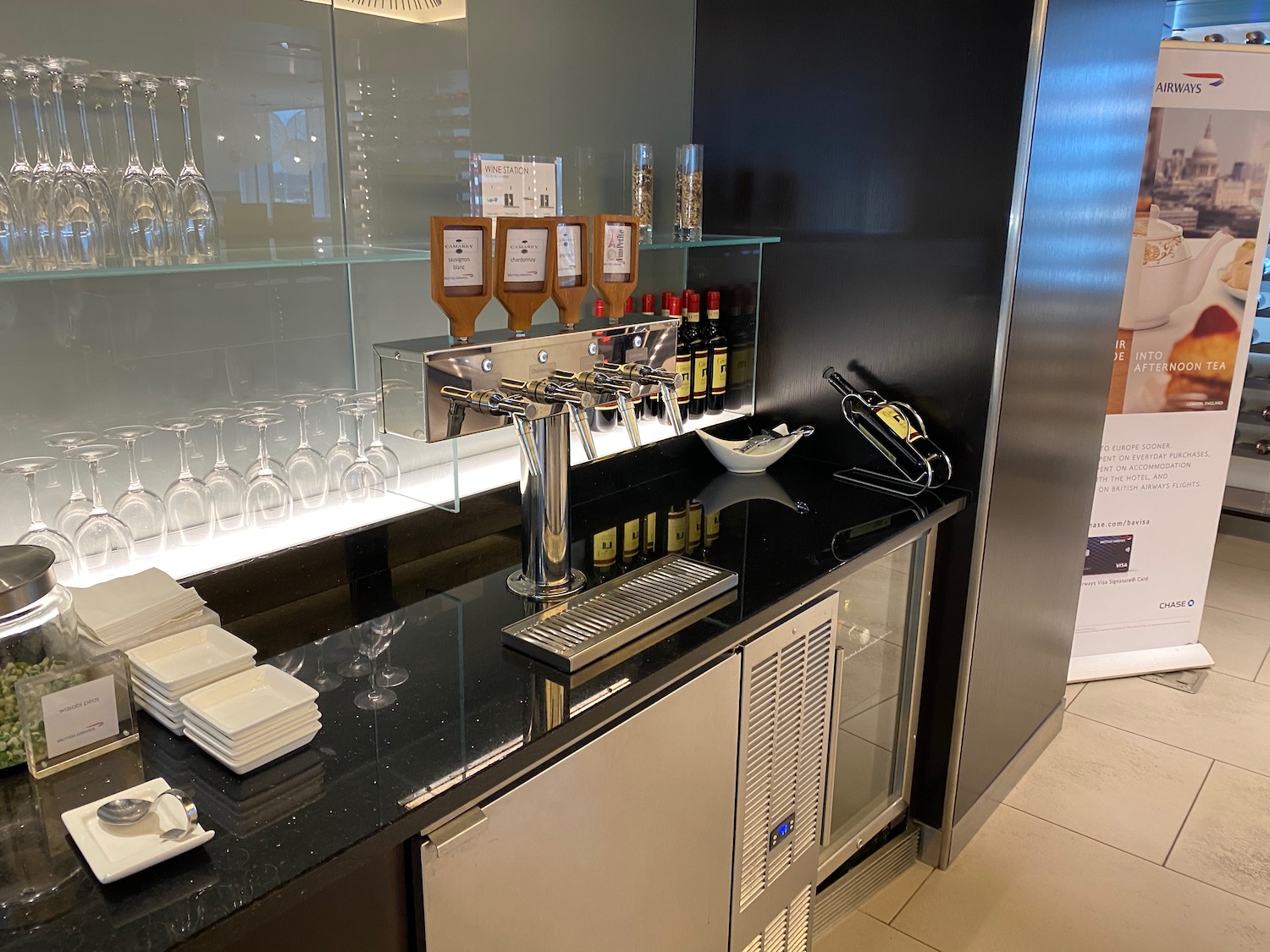 a bar with wine glasses and a dispenser