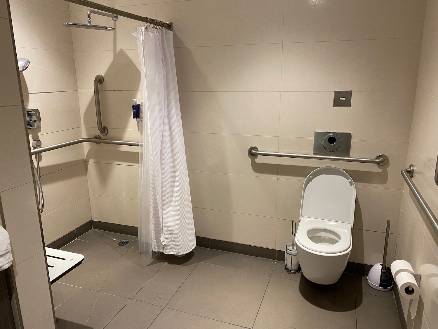 a bathroom with a toilet and shower curtain