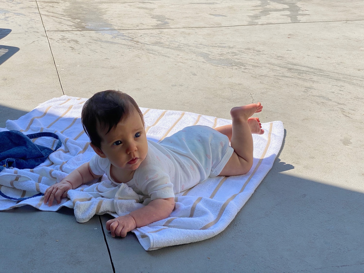 a baby lying on a towel