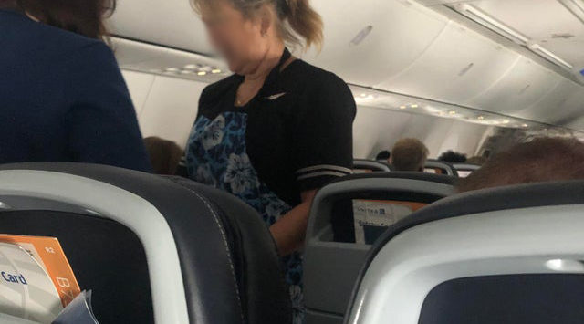 a woman standing in an airplane