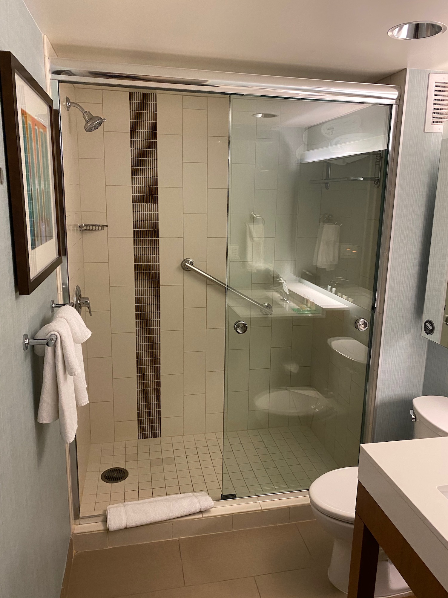 a bathroom with a glass shower door