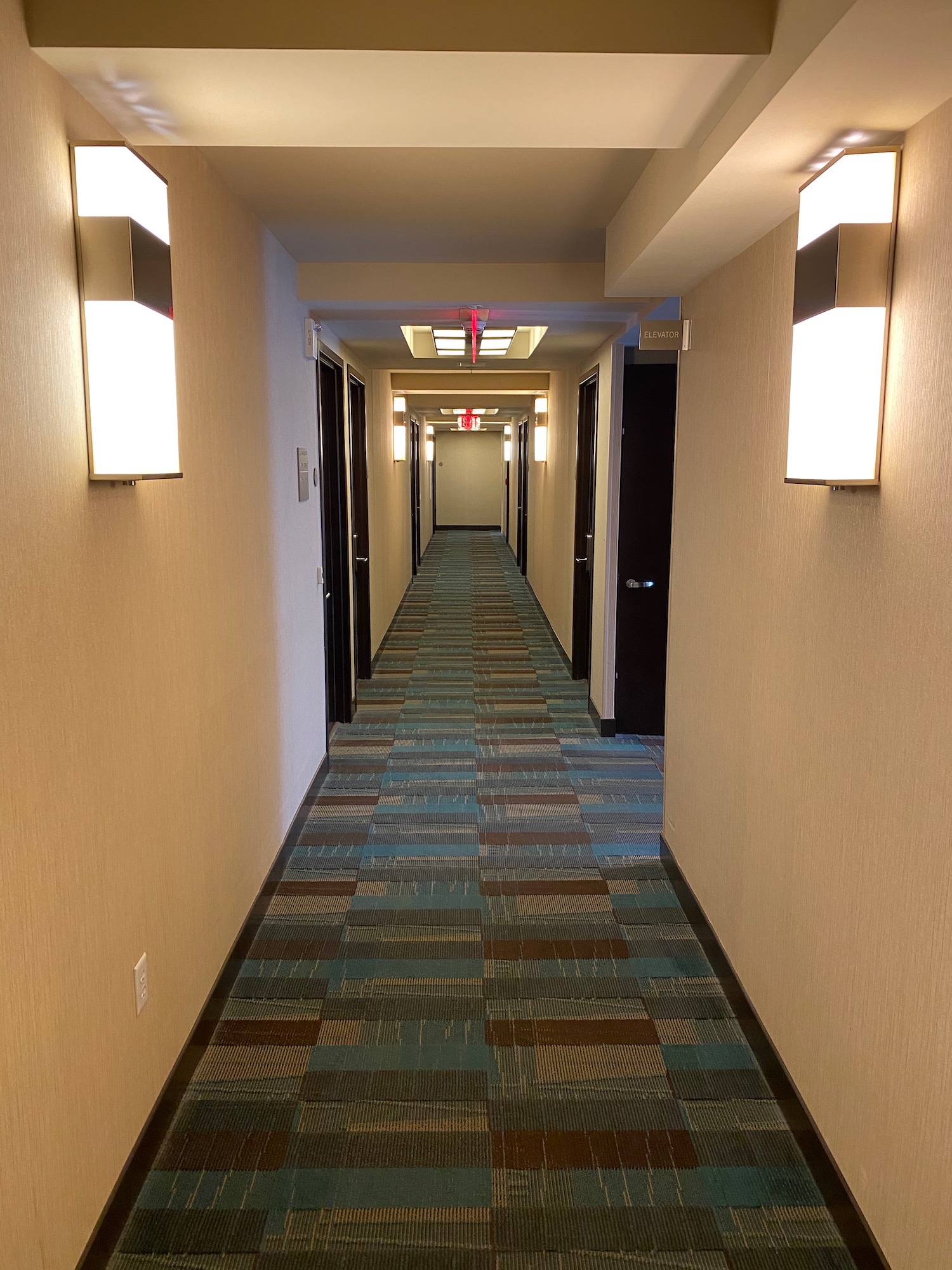 a hallway with lights on the wall