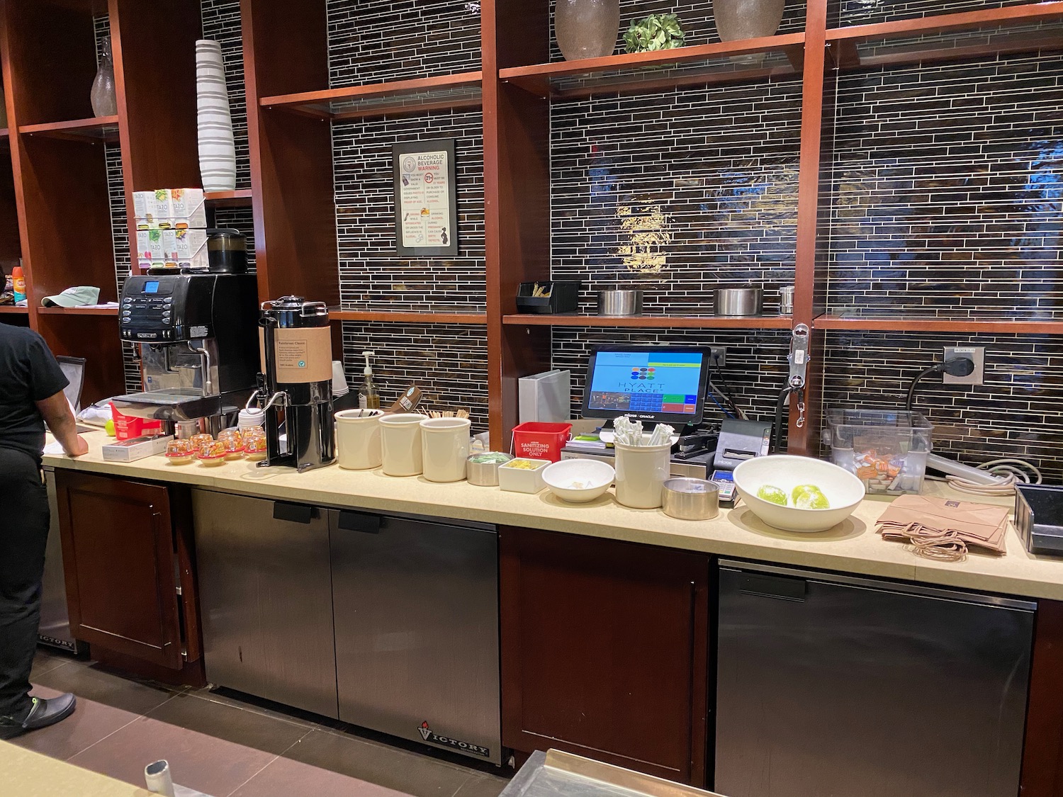 a counter with a computer and food on it