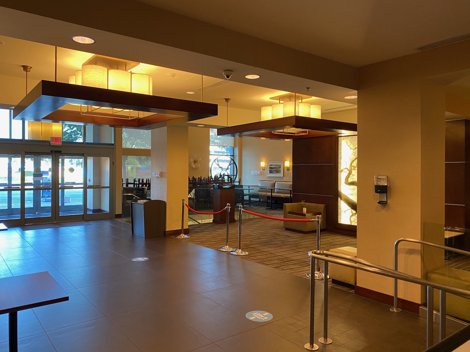 a lobby with a bar and a glass door