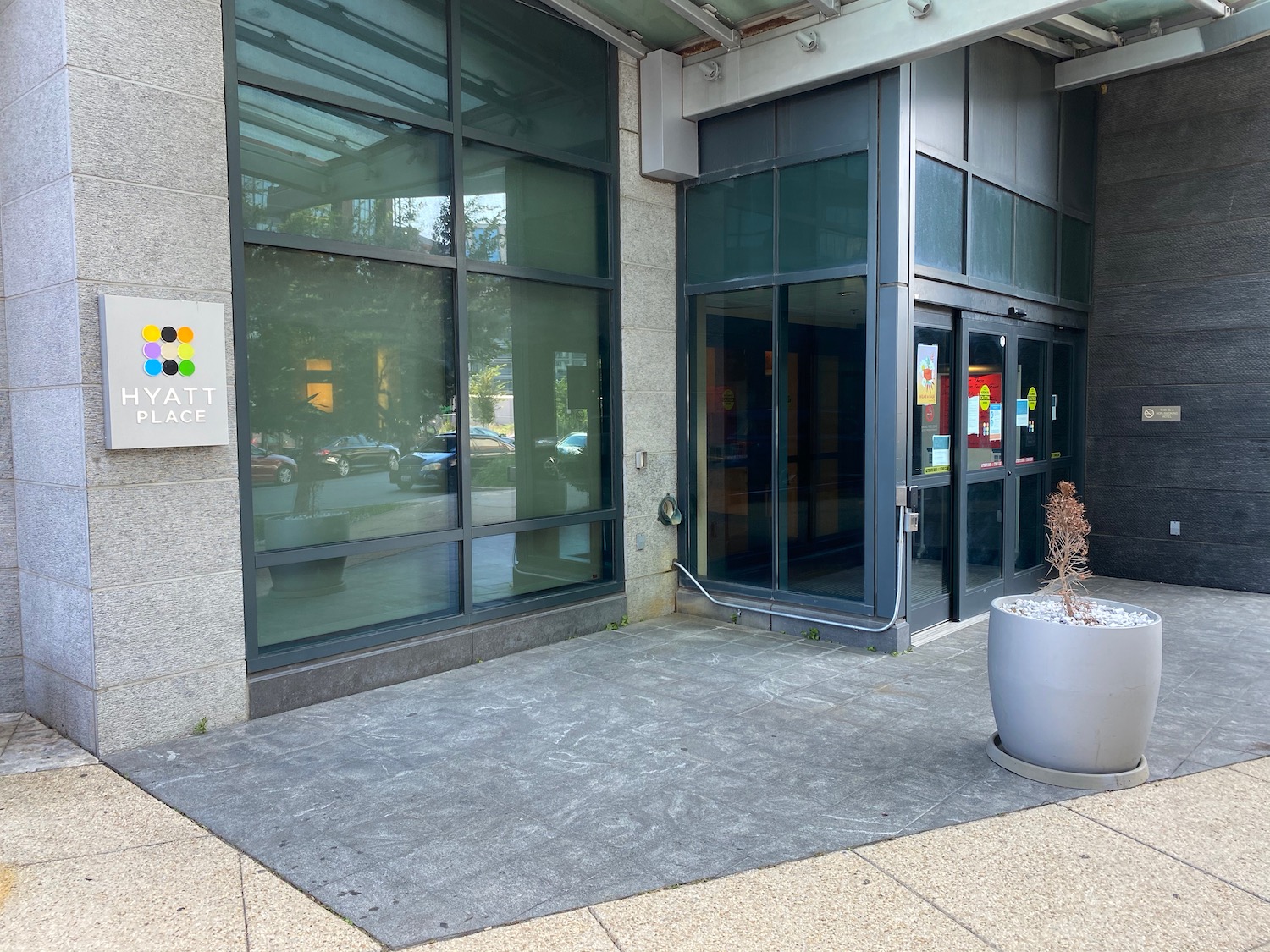 a building with glass doors and a potted plant