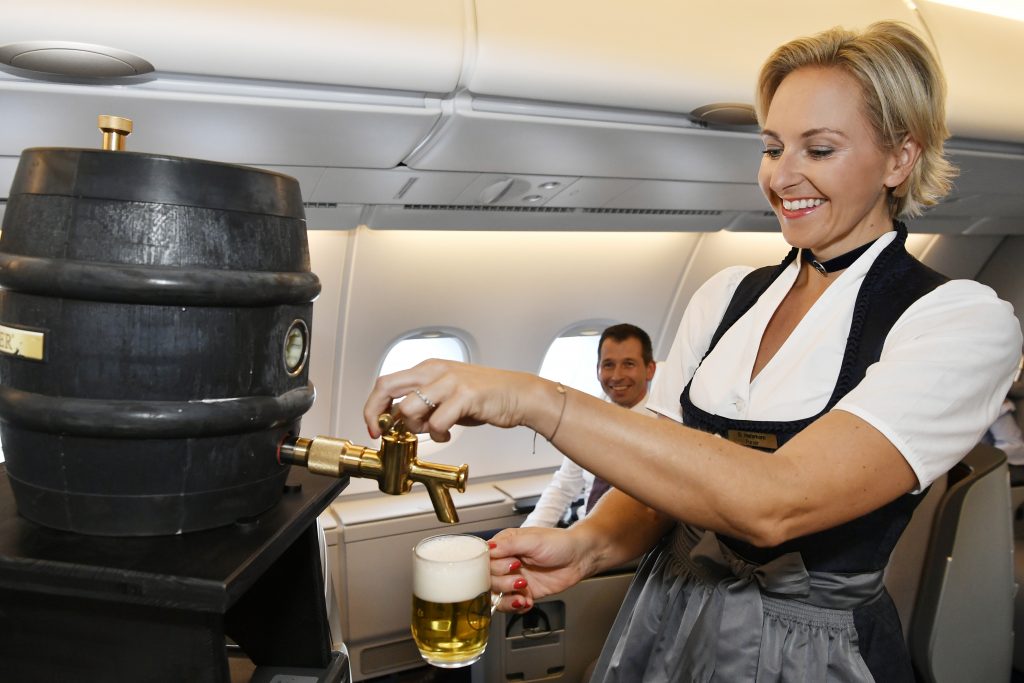 a woman pouring a drink from a beer dispenser