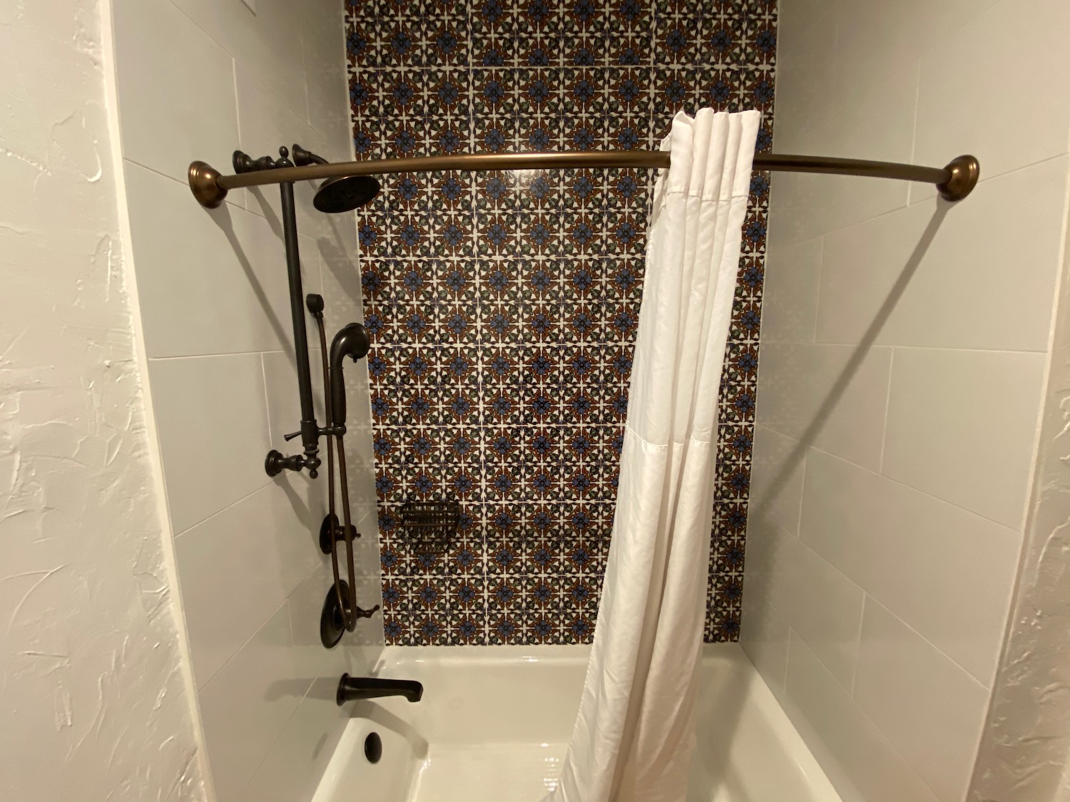 a shower with a white curtain