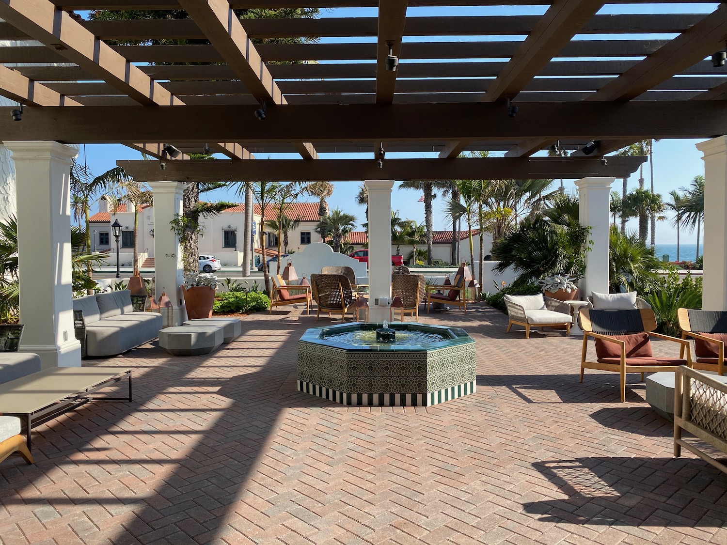 a patio with a fountain and chairs