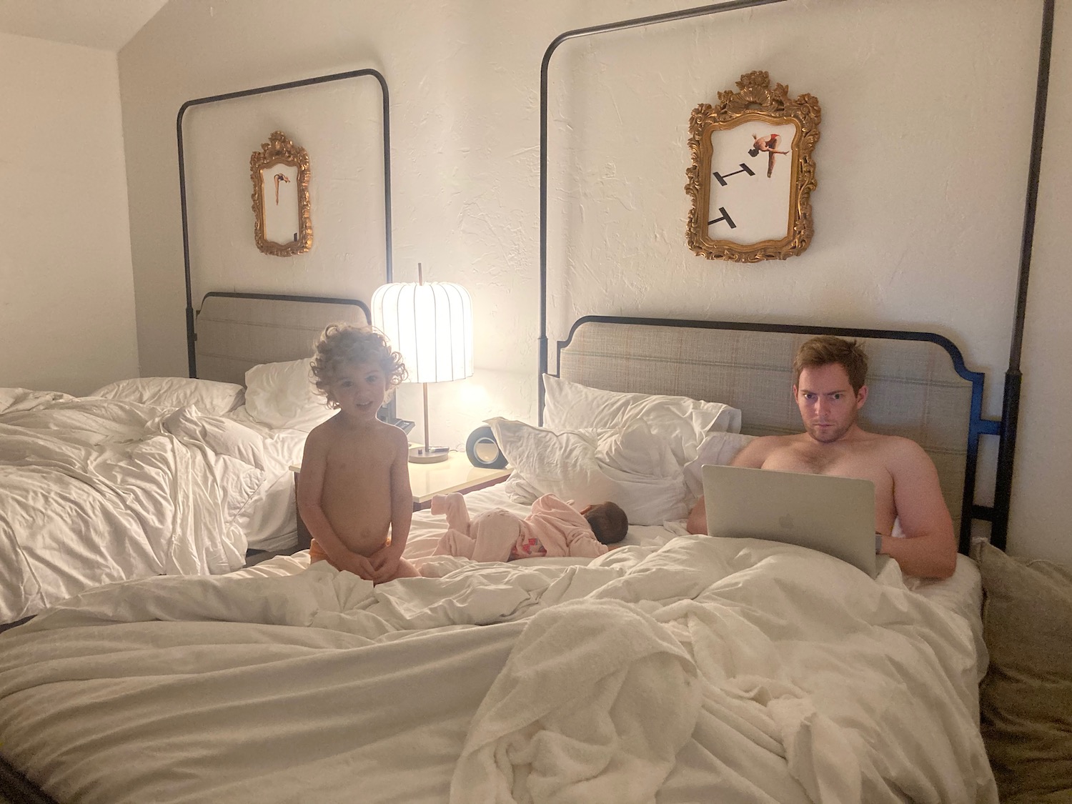 a man and two children in bed