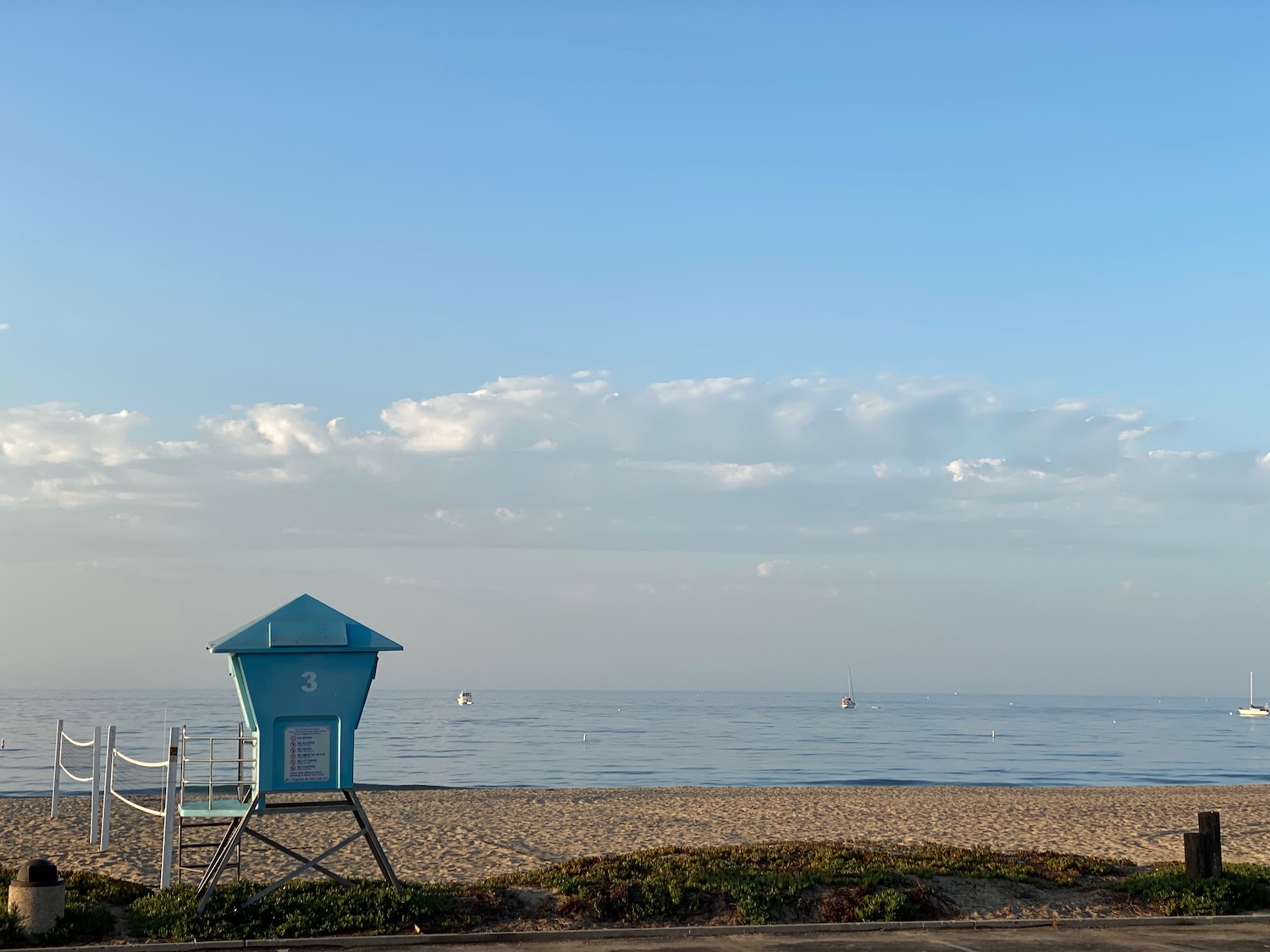 a blue lifeguard tower on a beach