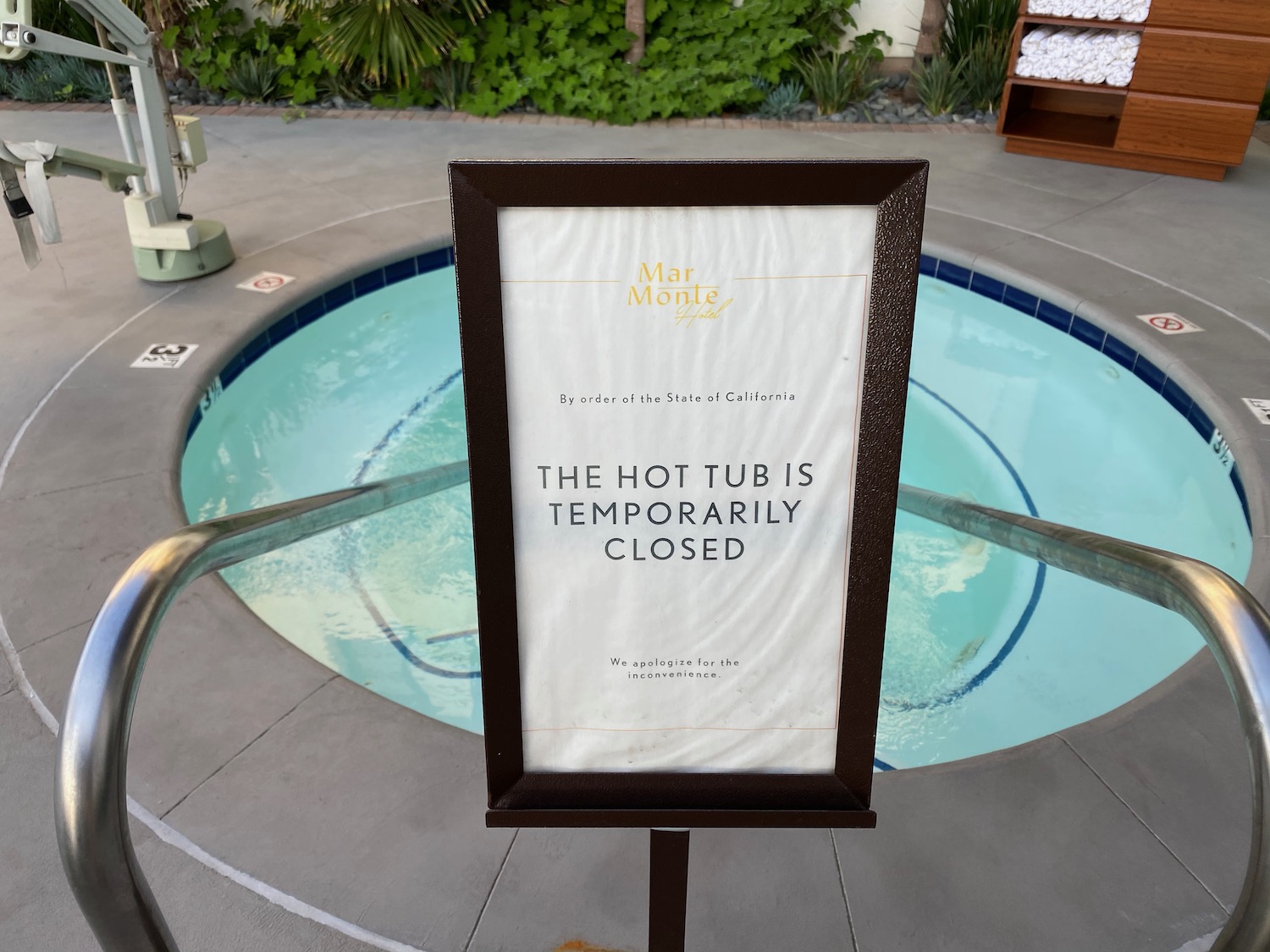a sign next to a hot tub
