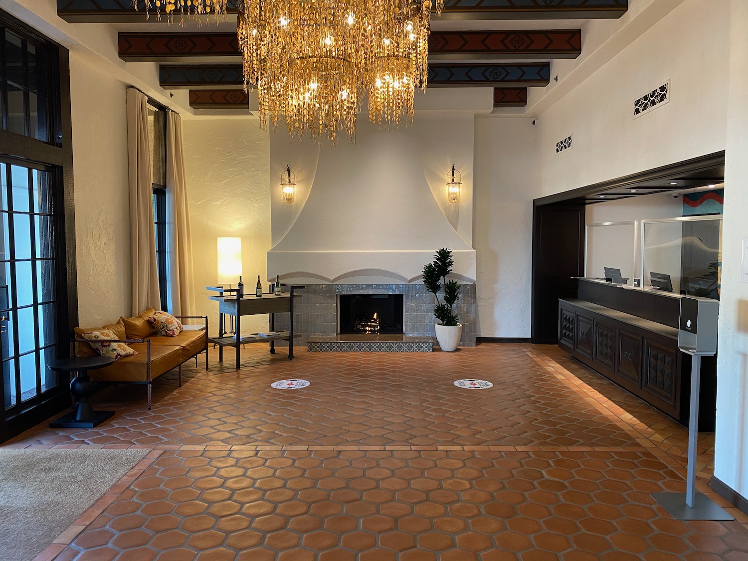 a room with a fireplace and chandelier