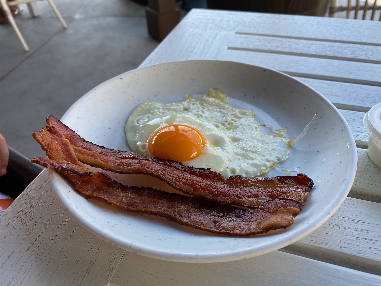 a plate of bacon and egg