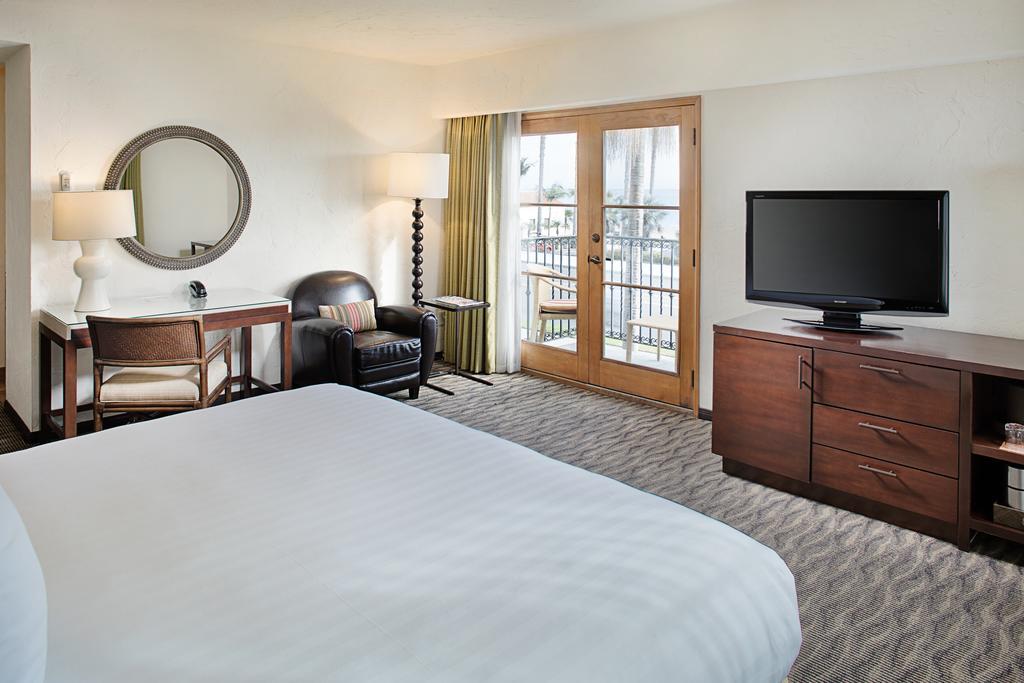 a hotel room with a television and a chair