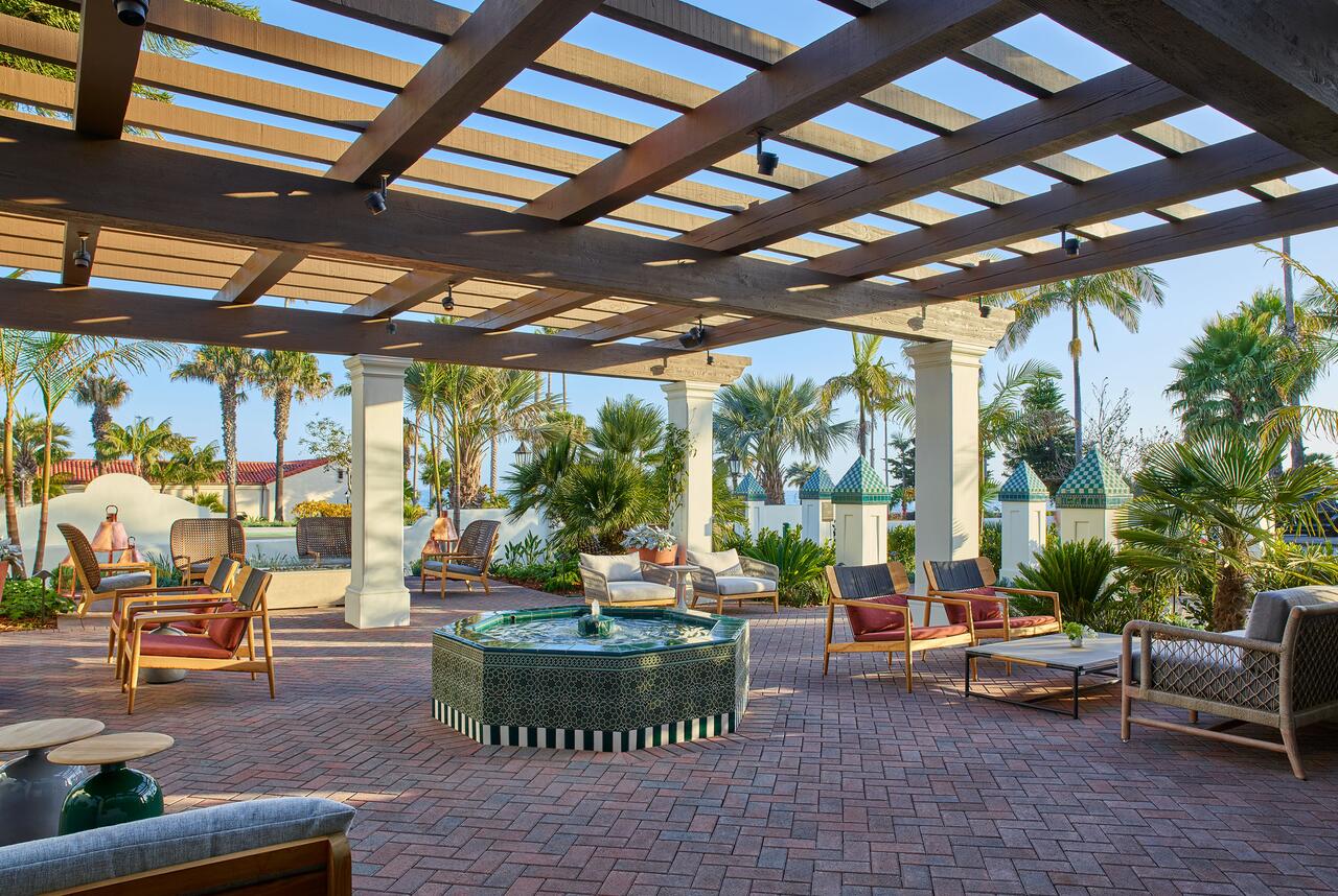 a patio with a fountain and chairs