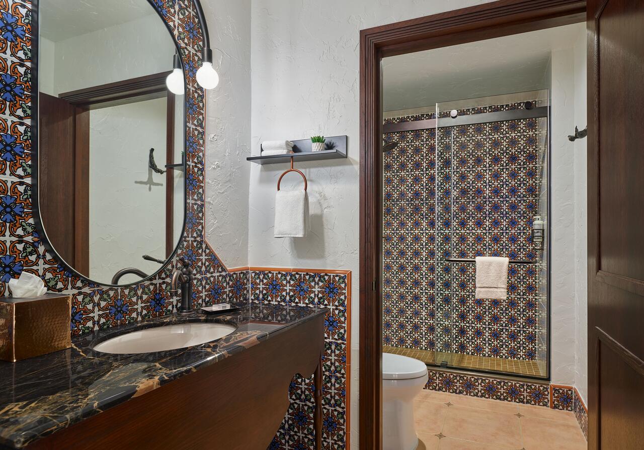 a bathroom with a mirror and a shower