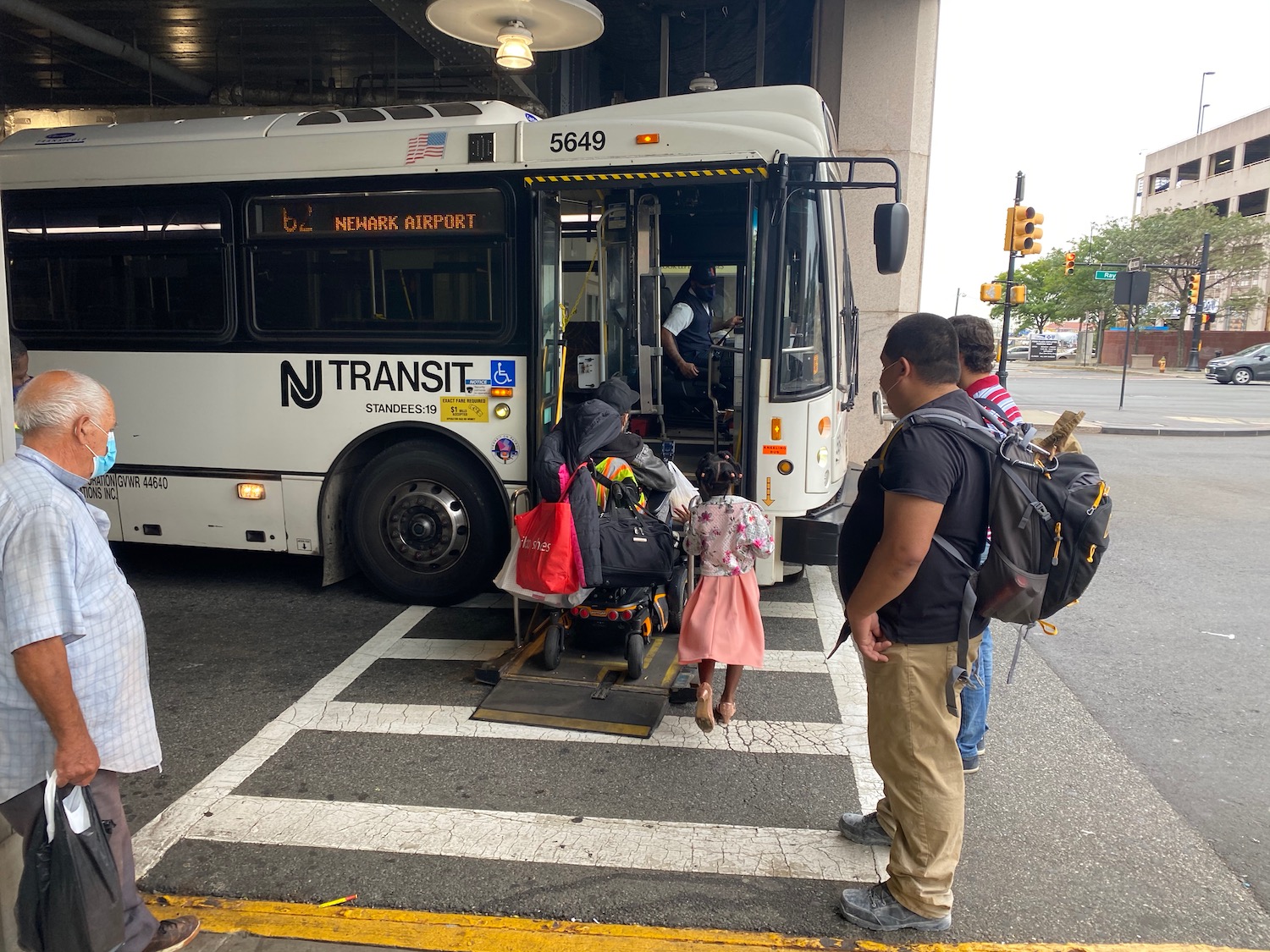 a group of people boarding a bus