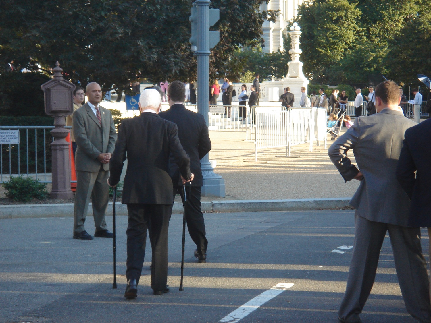 a group of men in suits walking on a street