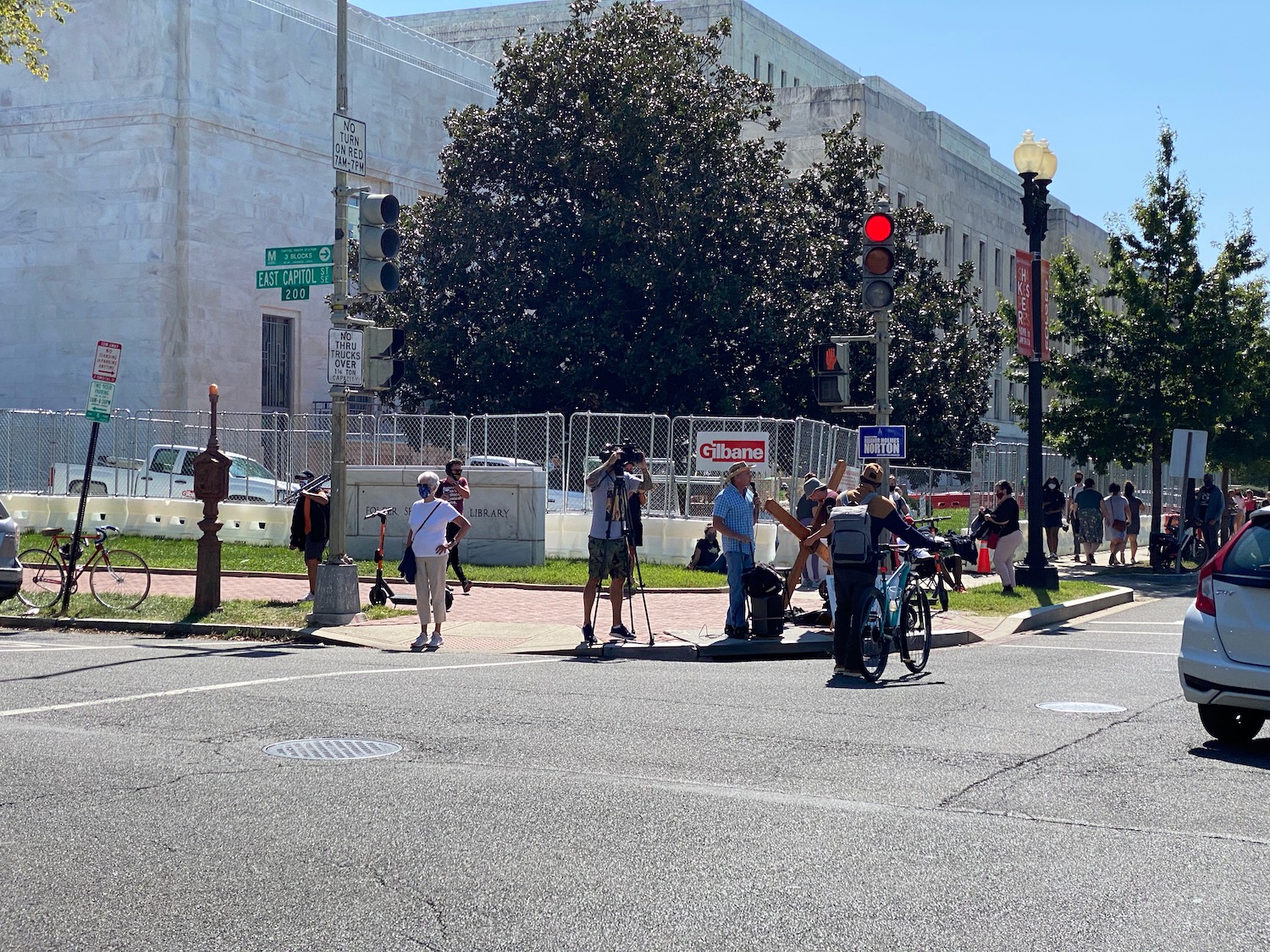 a group of people standing on a street corner