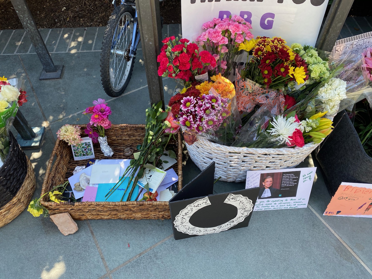 a basket of flowers and a sign