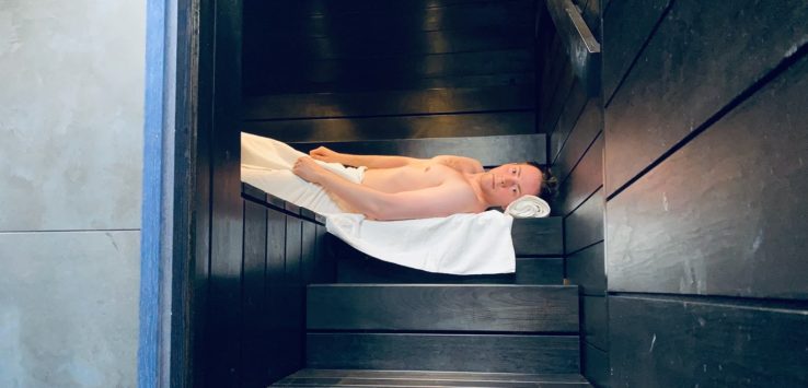 a man lying in a sauna
