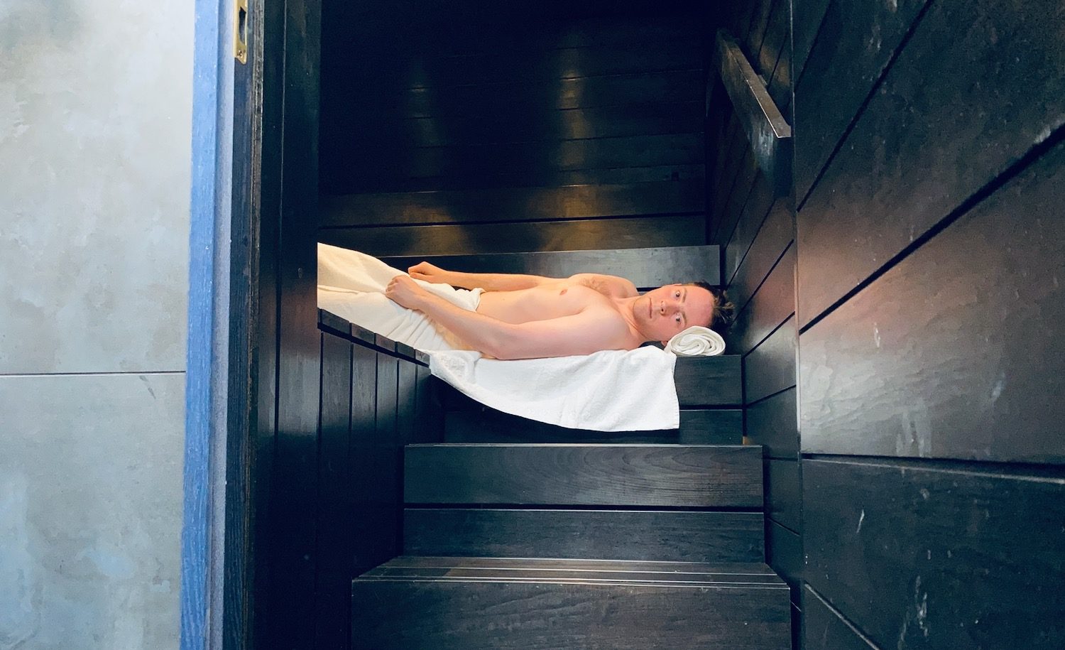 a man lying in a sauna