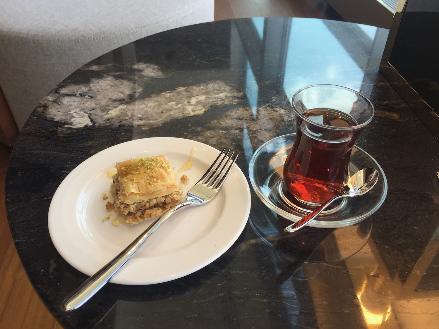 a plate of food and a glass of tea on a table