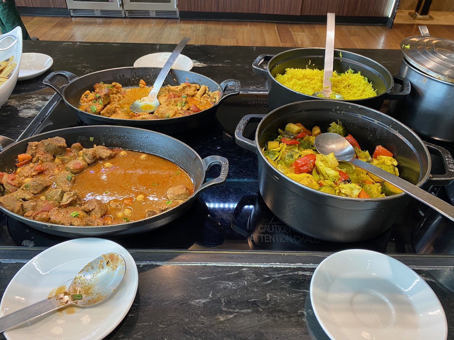 a group of pots of food on a counter