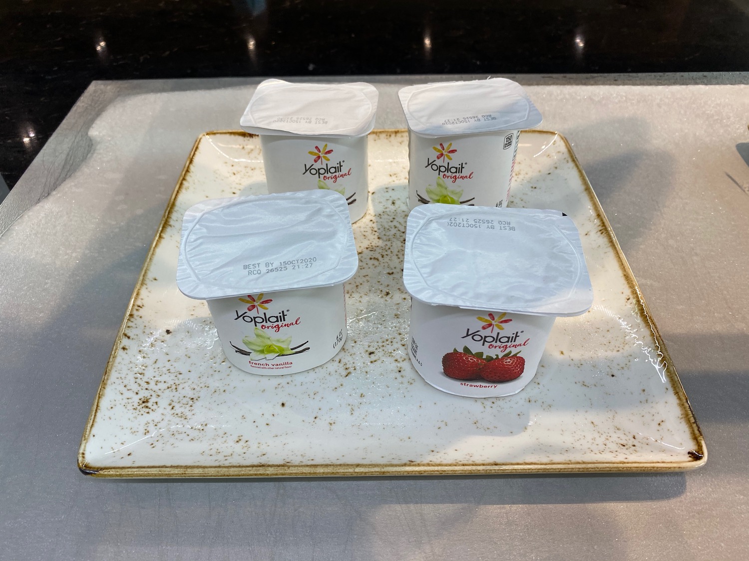 a group of yogurt containers on a plate