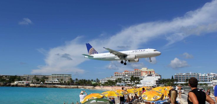 a plane flying over a beach