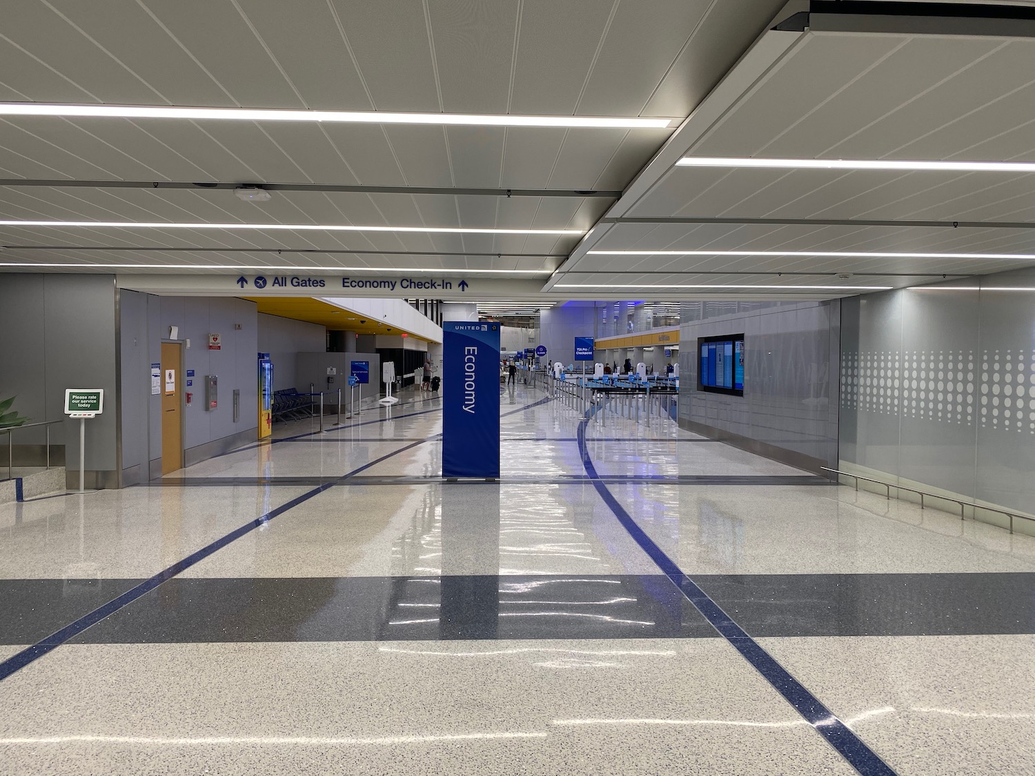 a large hall with a blue sign and a blue and white check-in area